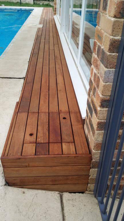 Wooden poolside seating and storage